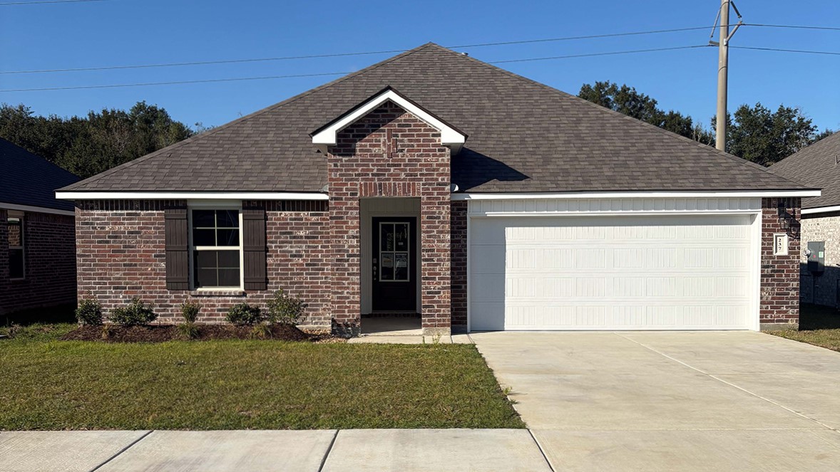 front exterior of a home with brown stone exterior and a two car garage