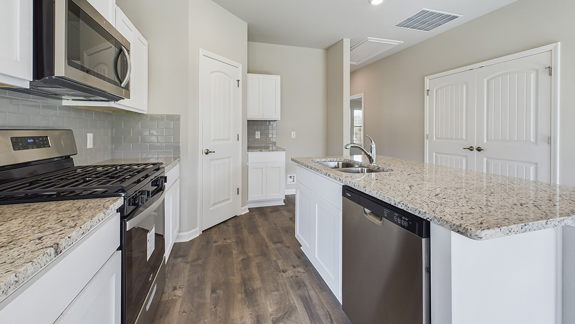 kitchen with white cabinetry, large island, and stainless steel appliances