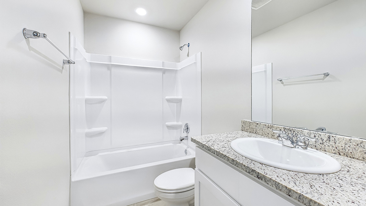 bathroom with a vanity sink, toilet and shower