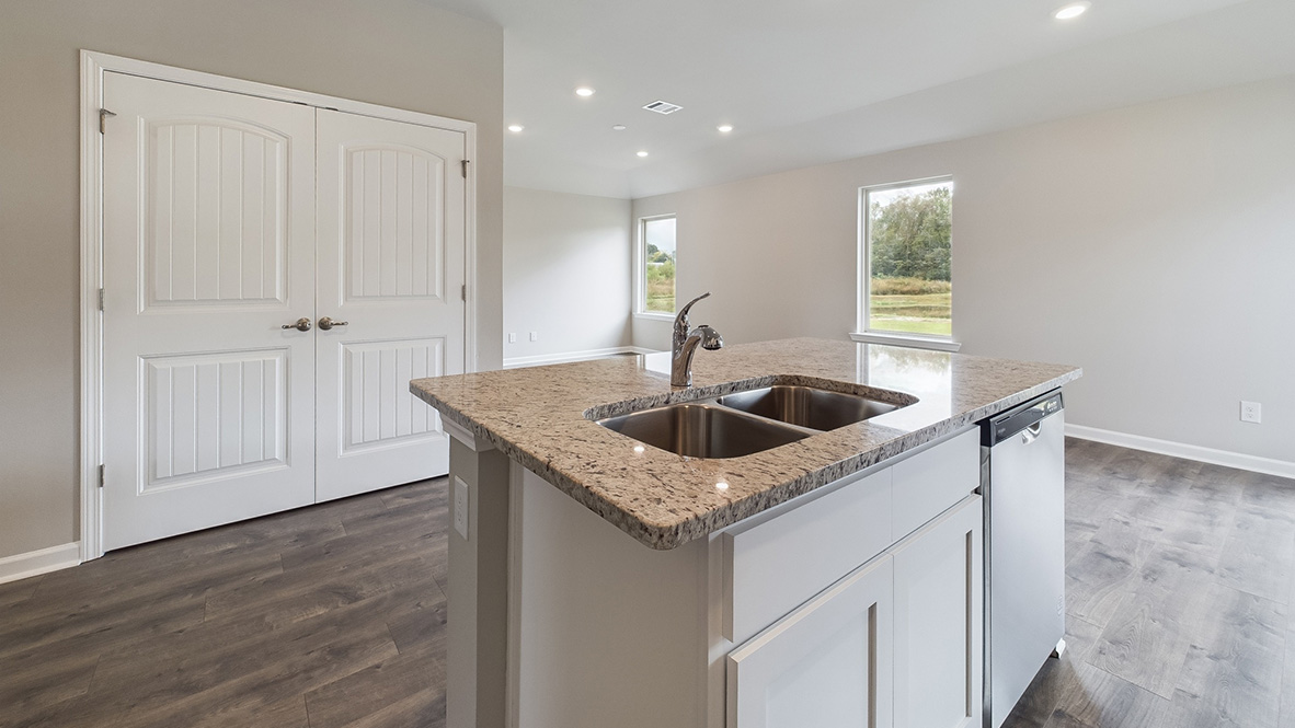 kitchen with white cabinetry, large island, and stainless steel appliances