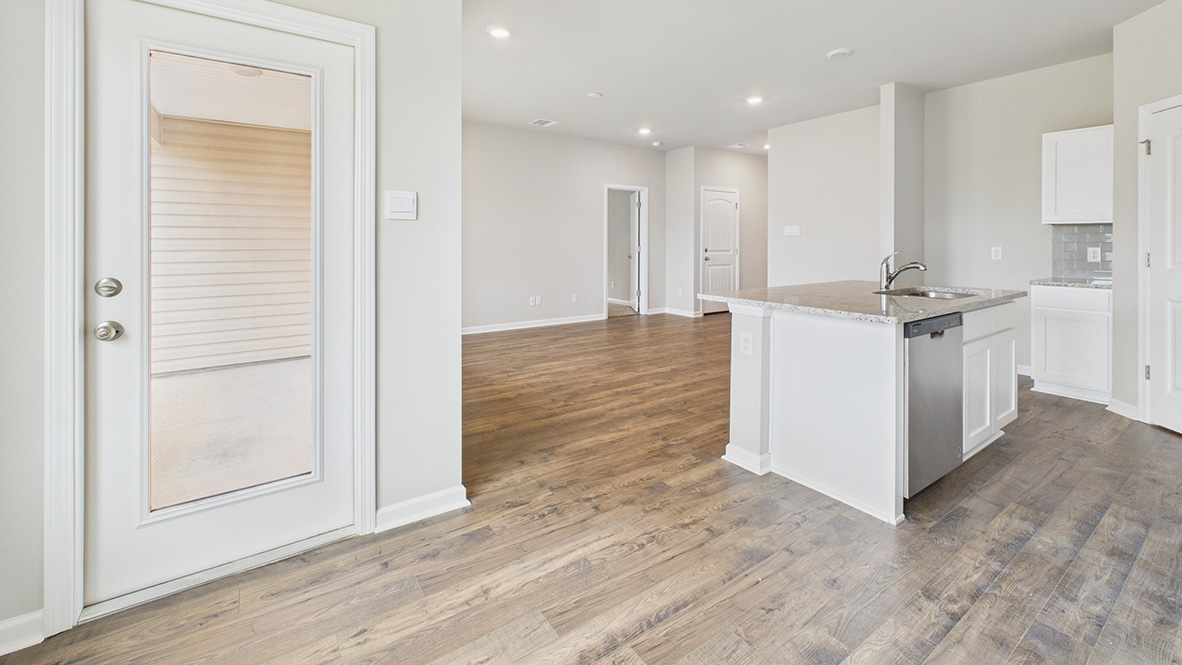 Bright dining area with neutral walls off the kitchen.