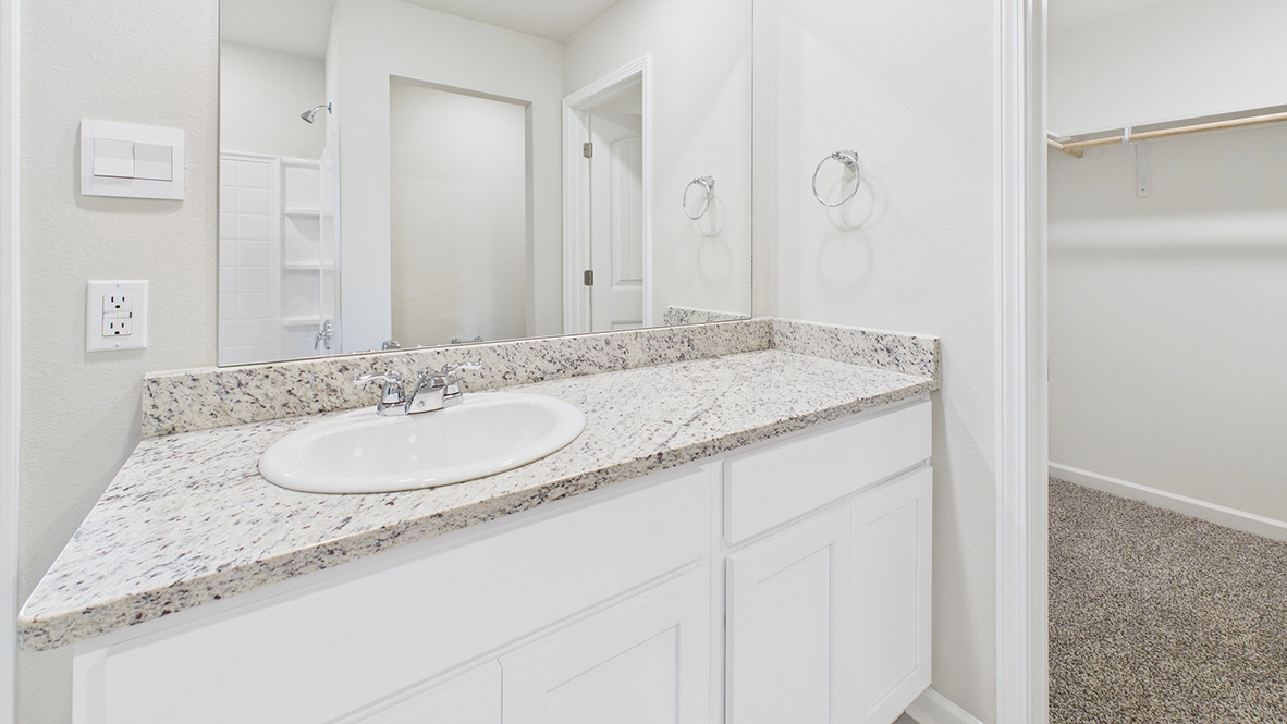Bathroom with a sink and large mirror.