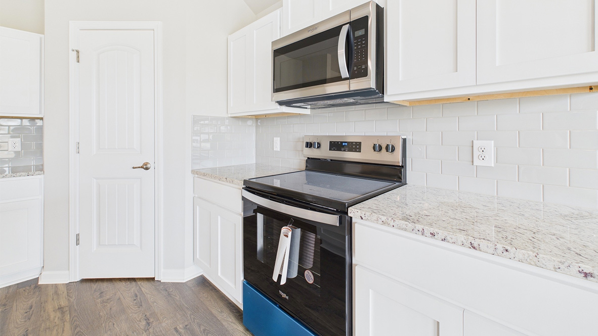 Kitchen featuring cabinets, new stainless steel appliances, and a large standing island.