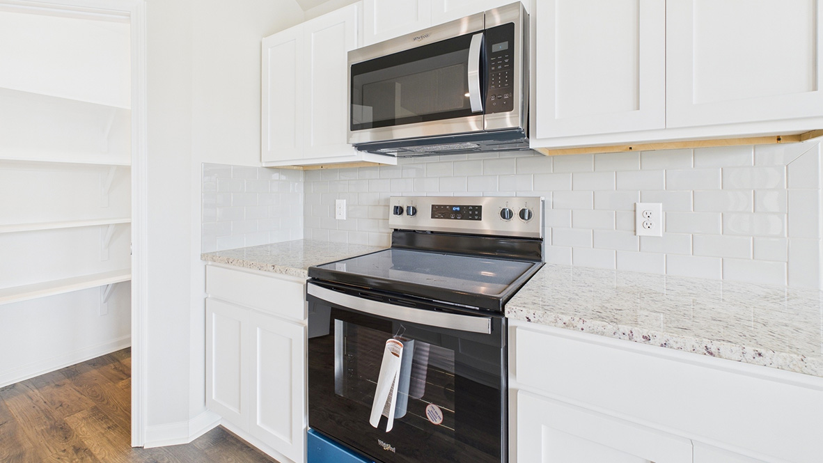 Kitchen with new hard surface countertops and new stainless steel appliances.
