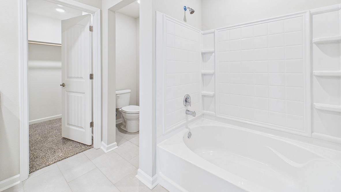 Owner’s ensuite in a new build home offers function and style with a walk-in closet, spa-like ensuite