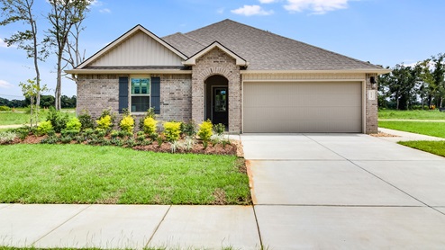 The Hollis Heights model home is a single story new home with brick exterior and two car garage.