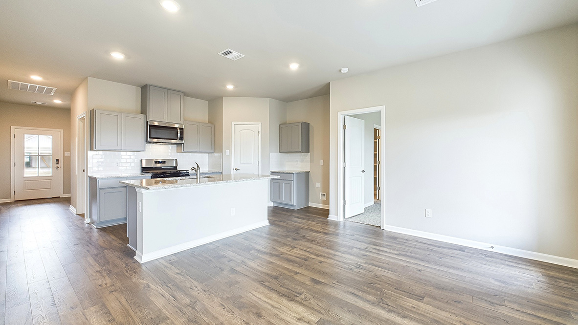 View from great room into kitchen with new appliance suite included, pantry, cabinet options at Hollis Heights