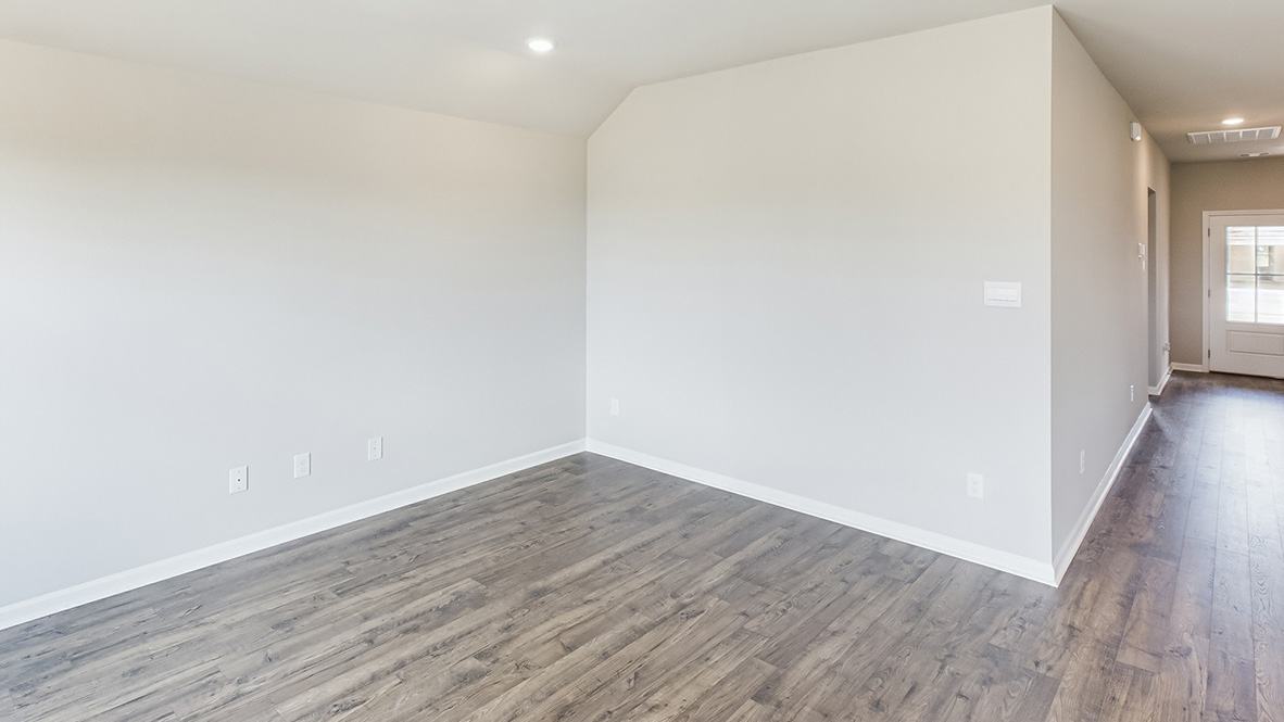 Living room looking to dining area in this new home featuring natural light, with fresh open concept flow to outside
