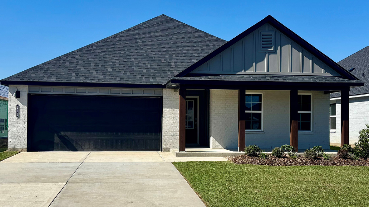 front exterior of a one story home with white brick, grey siding and a two car garage