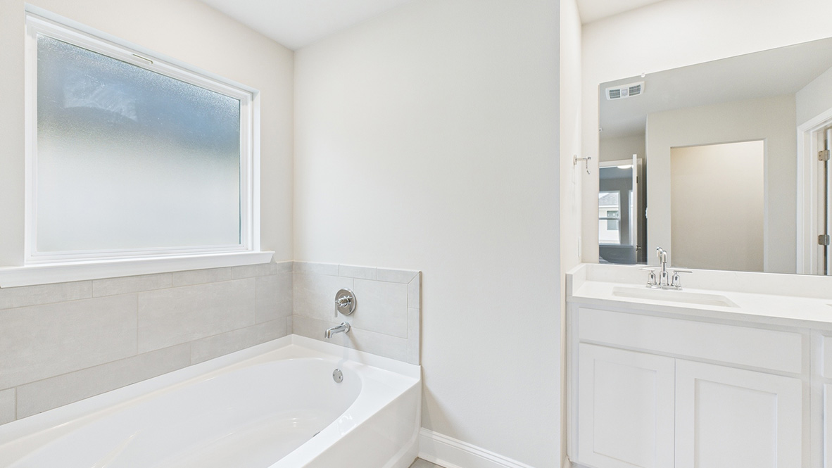 bathroom with dual vanity sinks, toilet, bath tub and a walk in shower