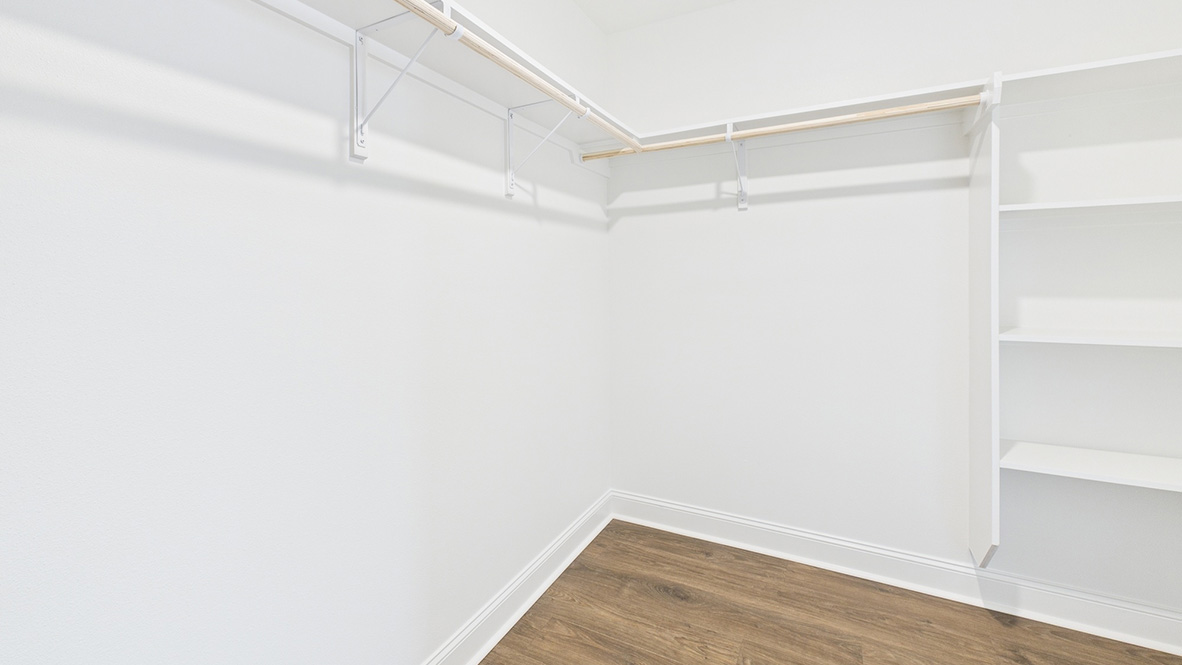 Walk-in closet with shelving and rods
