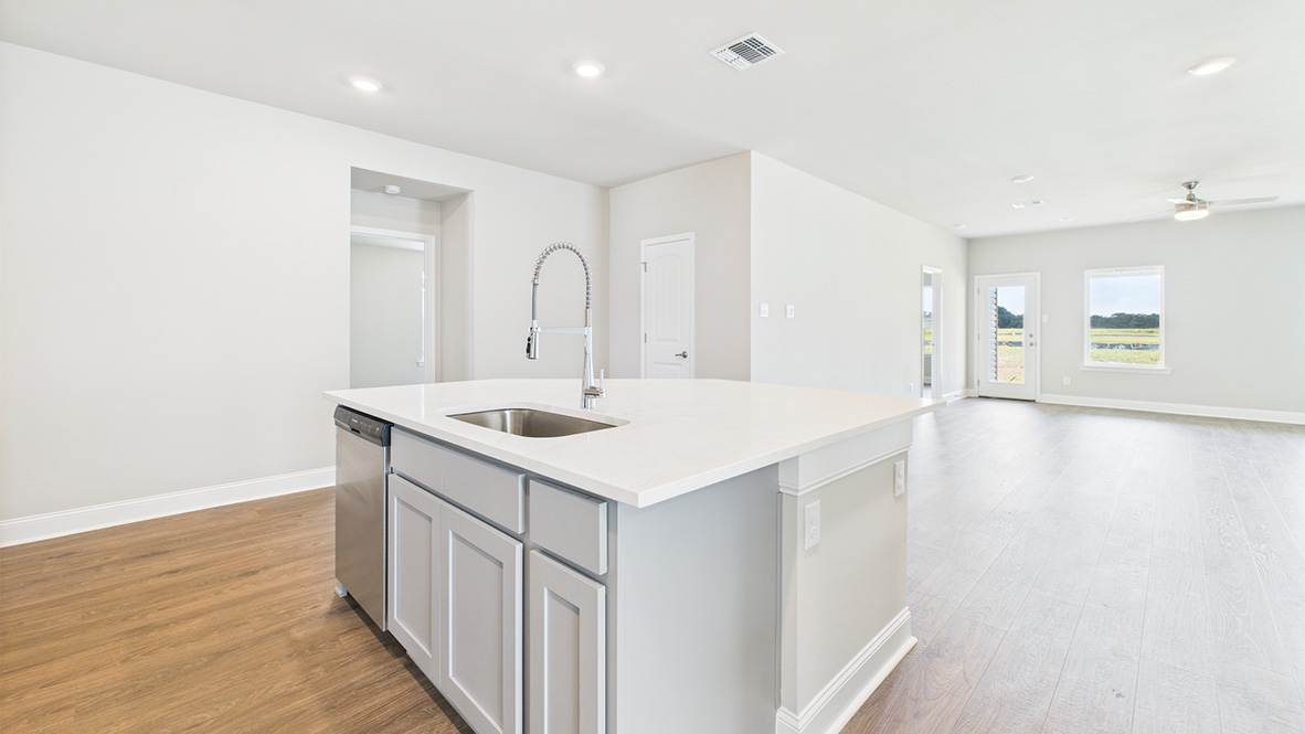 Functional kitchen island adds a sink, multi-prep zones, cabintes and a pantry, new appliance suite, and outside access