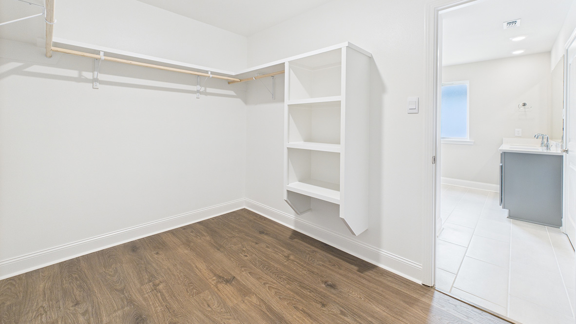 Interior view of walk-in closet in the primary bedroom and spa-inspired ensuite in Ridgeland, a new home by D.R. Horton