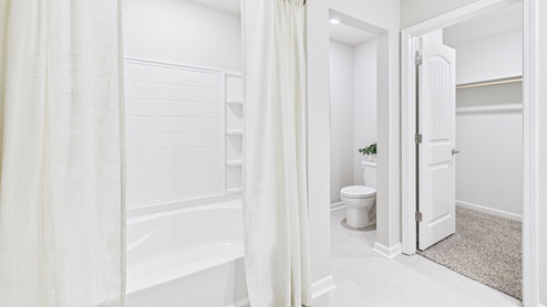 White cabinets and tile floors in bathrooms