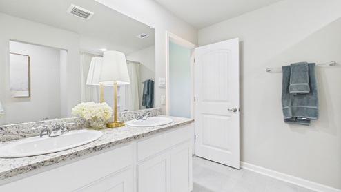 White cabinets and tile floors in bathrooms