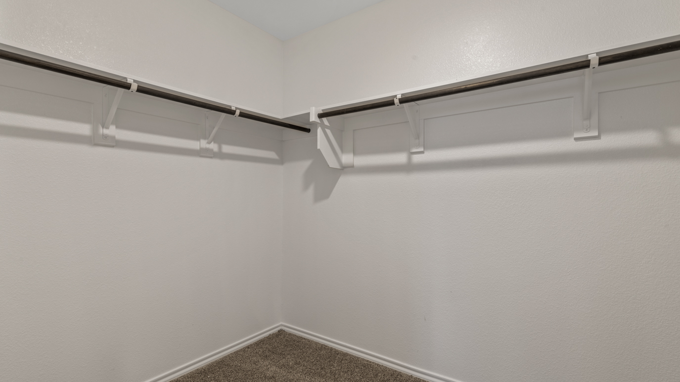 X40H Huntsville floorplan primary bedroom walk in closet rendering at Stonewyck Farms in Ennis TX