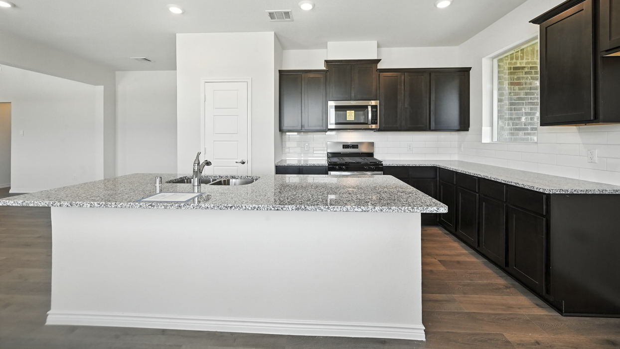 Stafford Floorplan Elevation B Kitchen Gallery Image - The Woods at Lindsey Place in Anna, TX