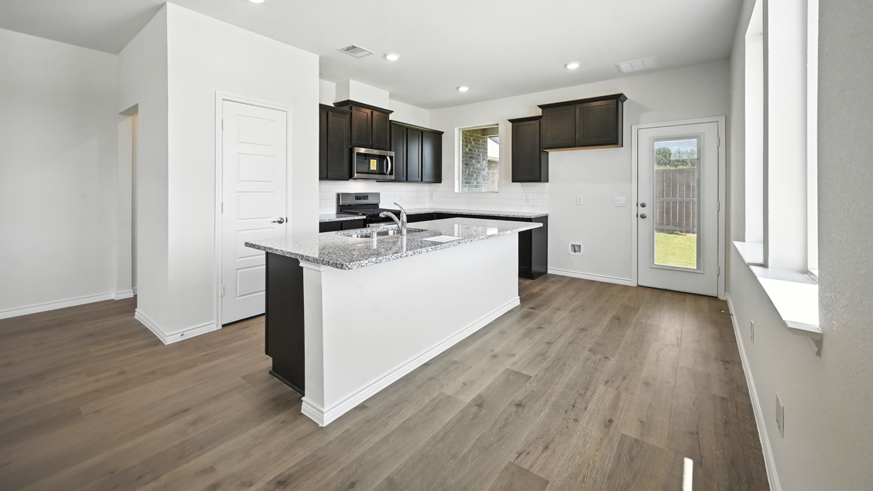 Stafford Floorplan Elevation B Kitchen Gallery Image - The Woods at Lindsey Place in Anna, TX