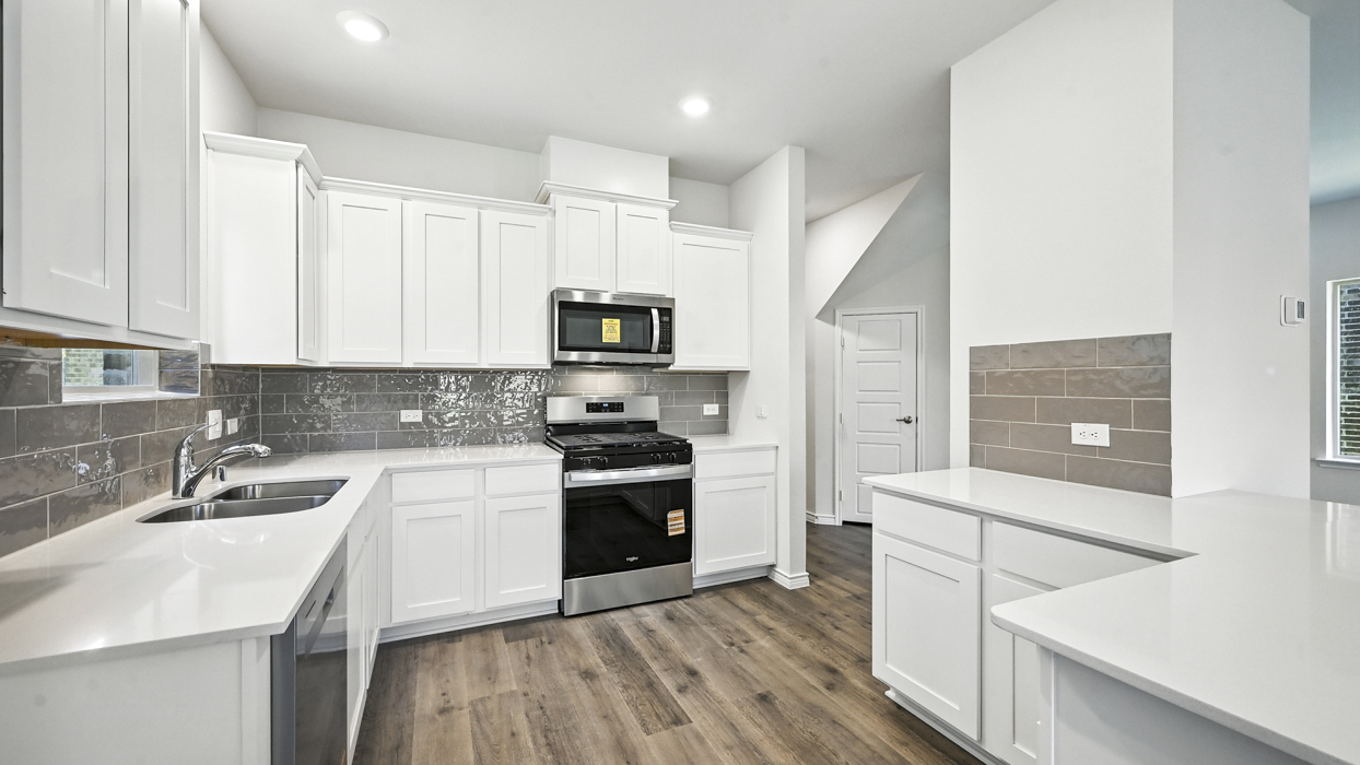 Aquamarine Floorplan Elevation B Kitchen Gallery Image - The Woods At Lindsey Place in Anna, TX