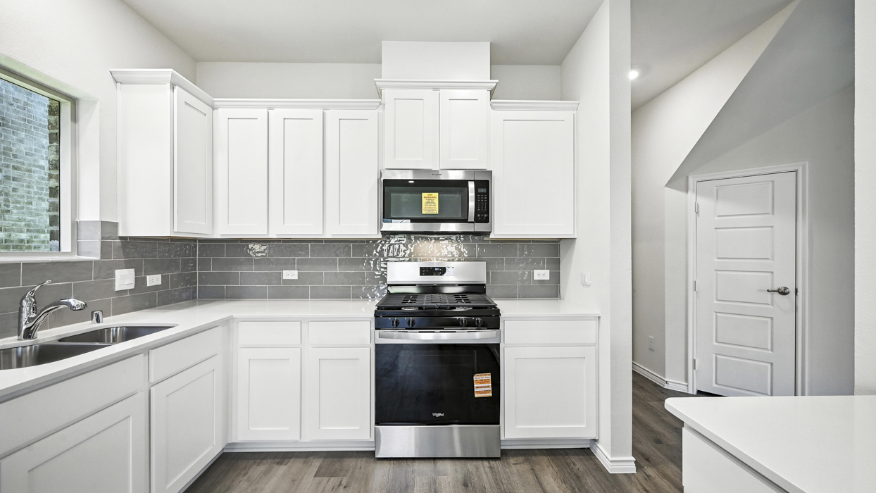 3215 Aquamarine Floorplan Kitchen Gallery Image-The Woods at Lindsey Place in Anna, TX