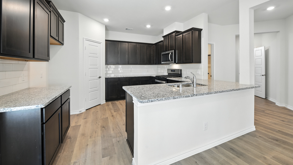 Amethyst Floorplan Elevation B Kitchen Gallery Image - The Woods at Lindsey Place in Anna, TX