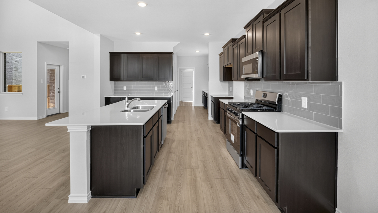 H222 Owens Floorplan Kitchen Gallery Image-Lilybrooke at Legacy Hill in Celina, TX