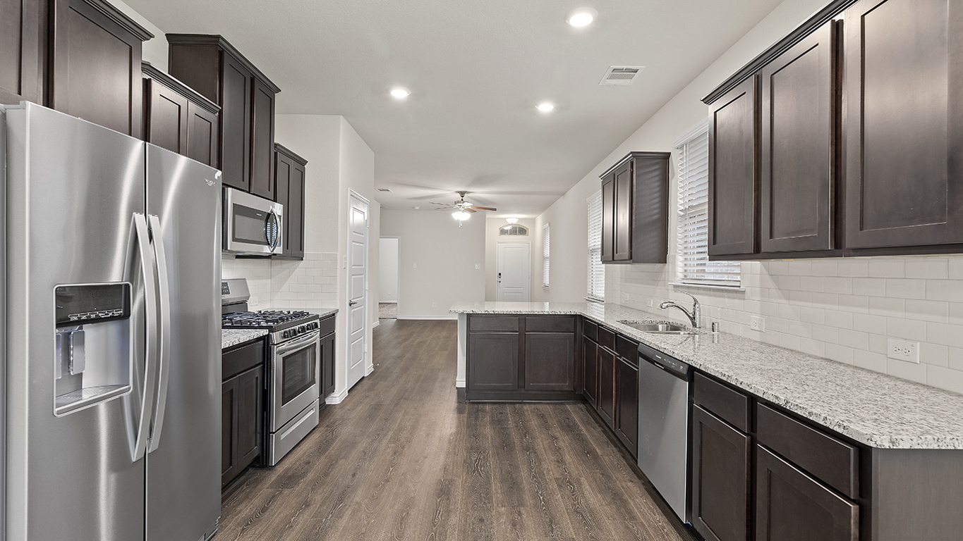 H122 Woodstock Floorplan Kitchen Gallery Image-Magnolia at Legacy Hills in Celina, TX