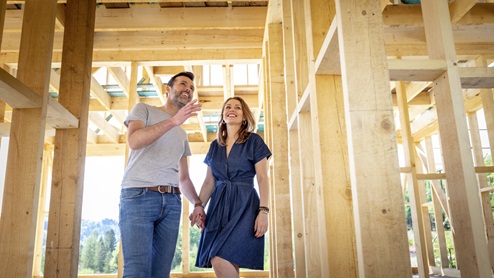 Couple looking at framed home