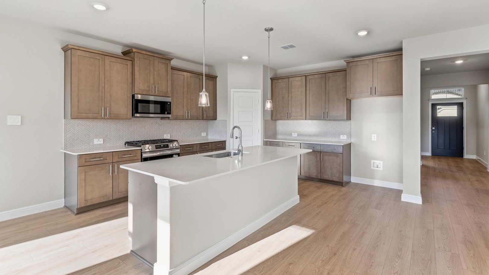 Kitchen with light brown cabinets and backsplash