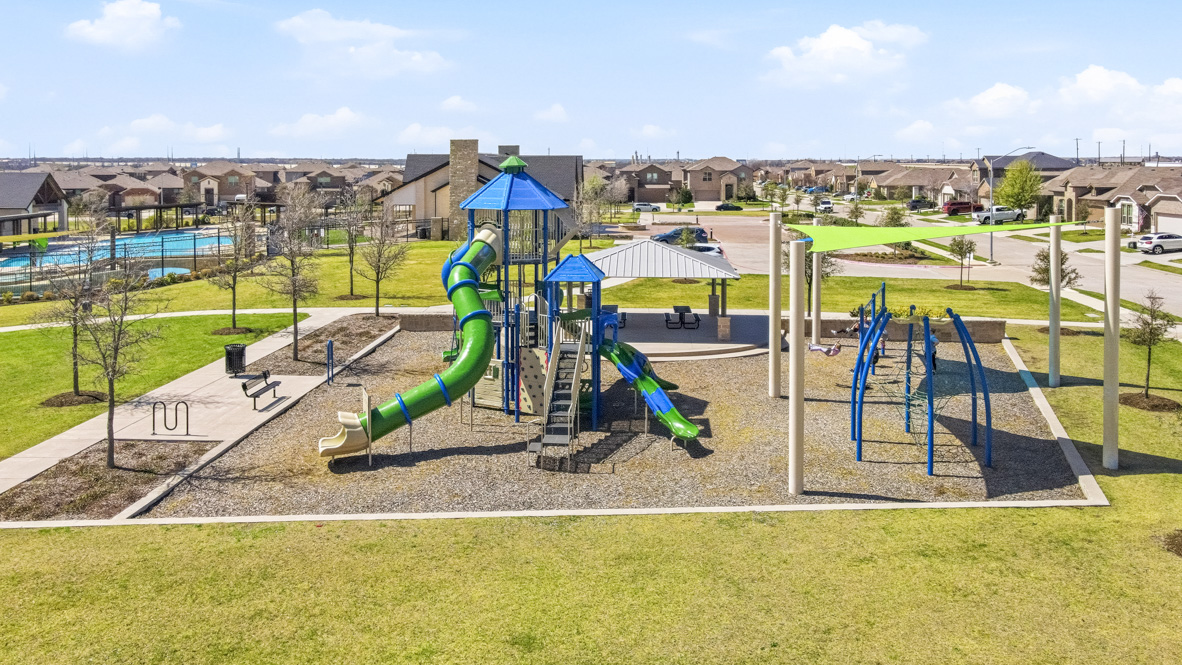 Community playground outside of pool and clubhouse space