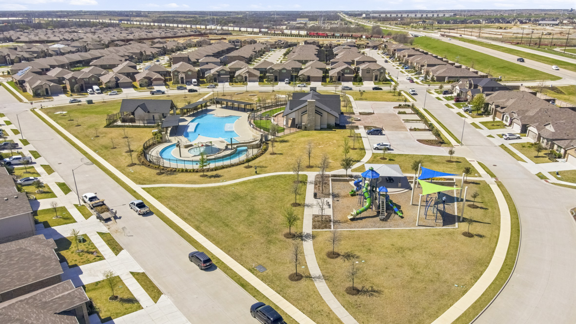 Aerial overview of community playground, pool, and clubhouse amenities