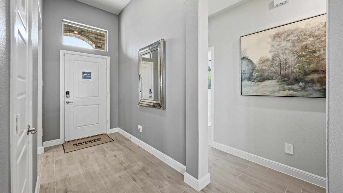 Front hallway with remaining bedrooms to the side and welcoming foyer at entry
