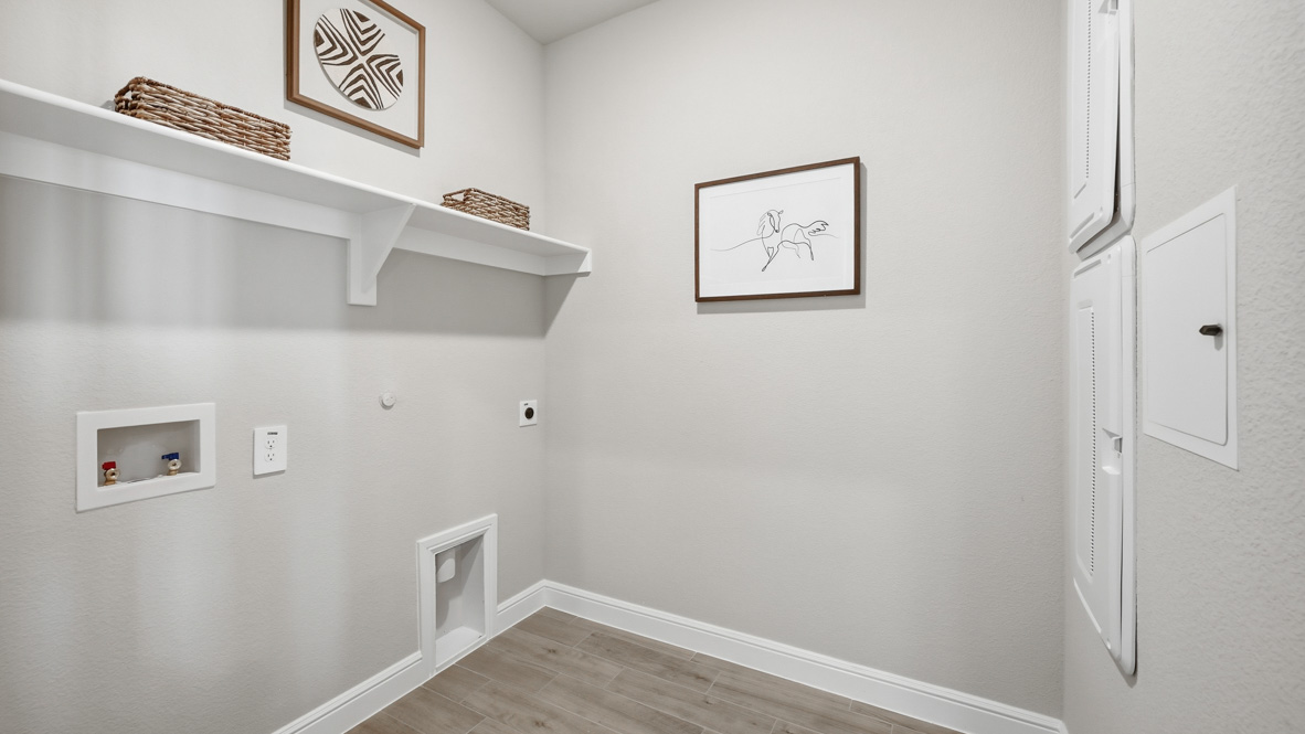Laundry room and utility closet with shelves for storage
