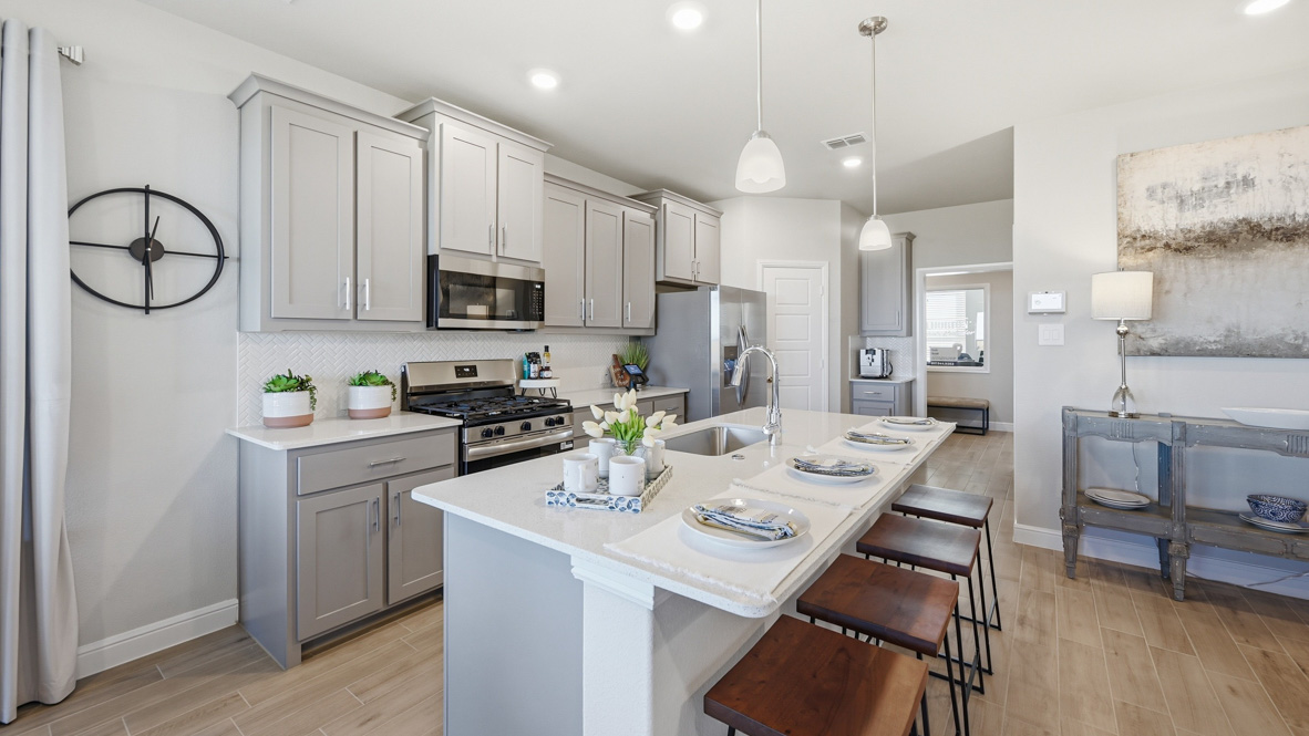 Open-concept kitchen overlooking living and family room space