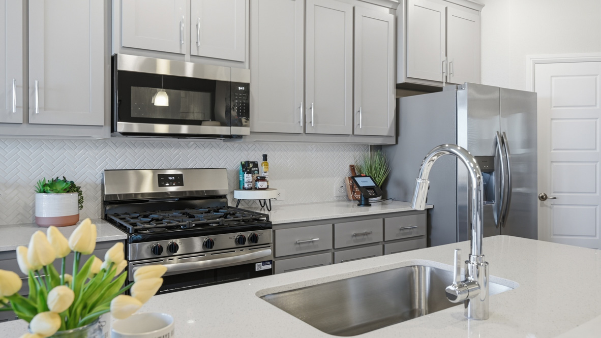 Large cabinets with ample storage and stainless steel appliances in kitchen
