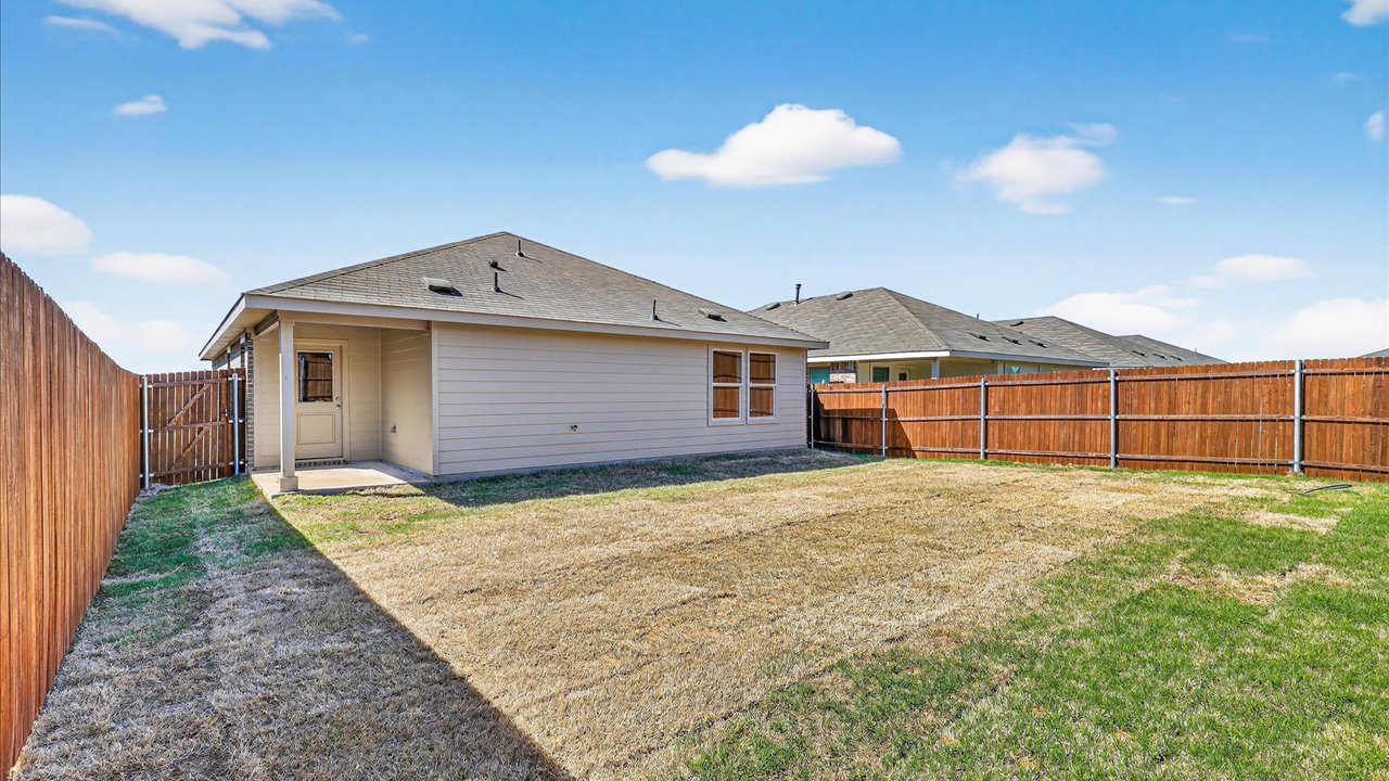 Covered back patio and spacious backyard