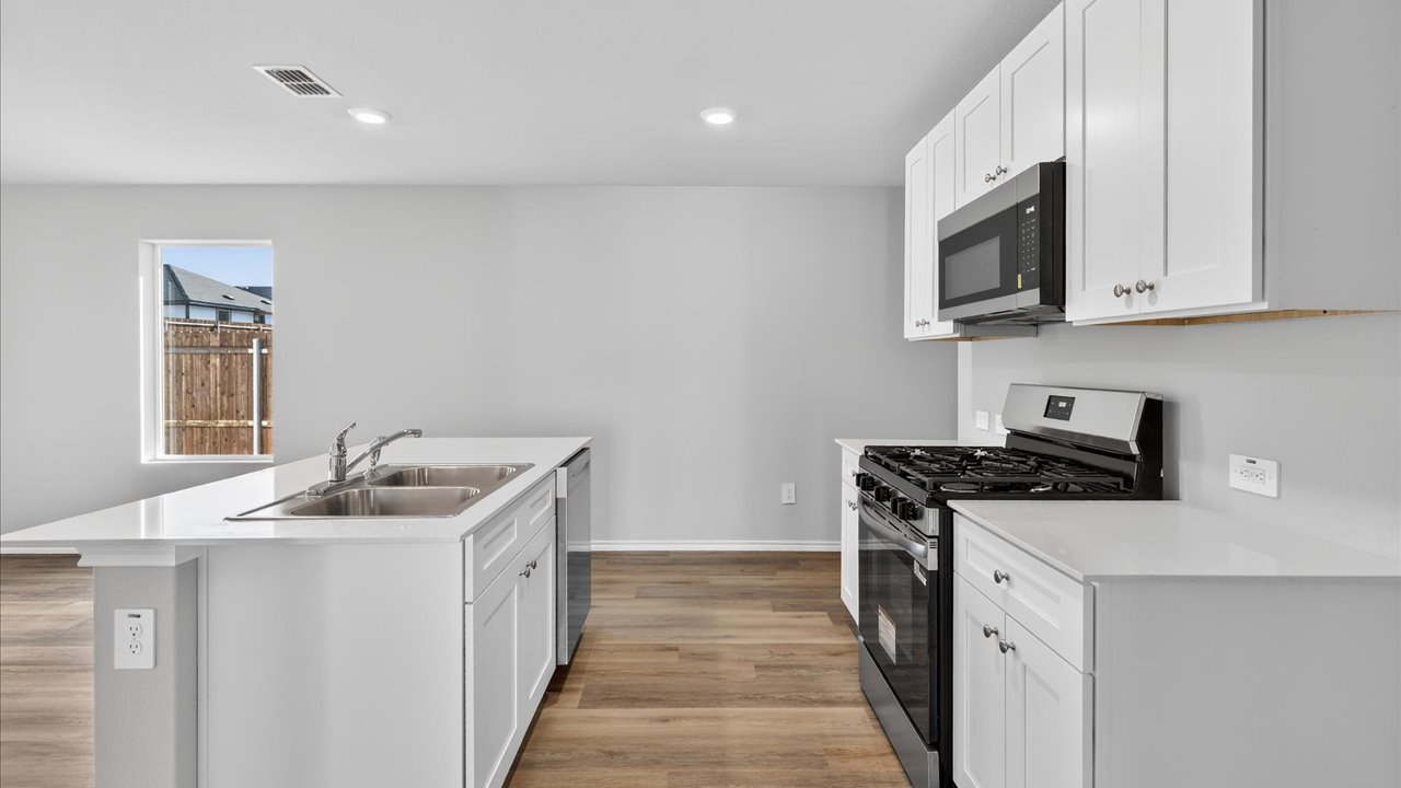 Kitchen with stainless steel appliances and spacious countertops