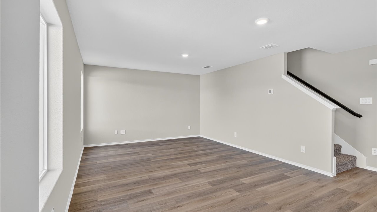Open living room space with staircase entry for upstairs