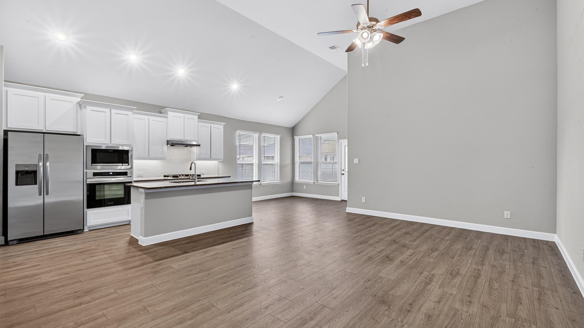 Open kitchen, dining, and living