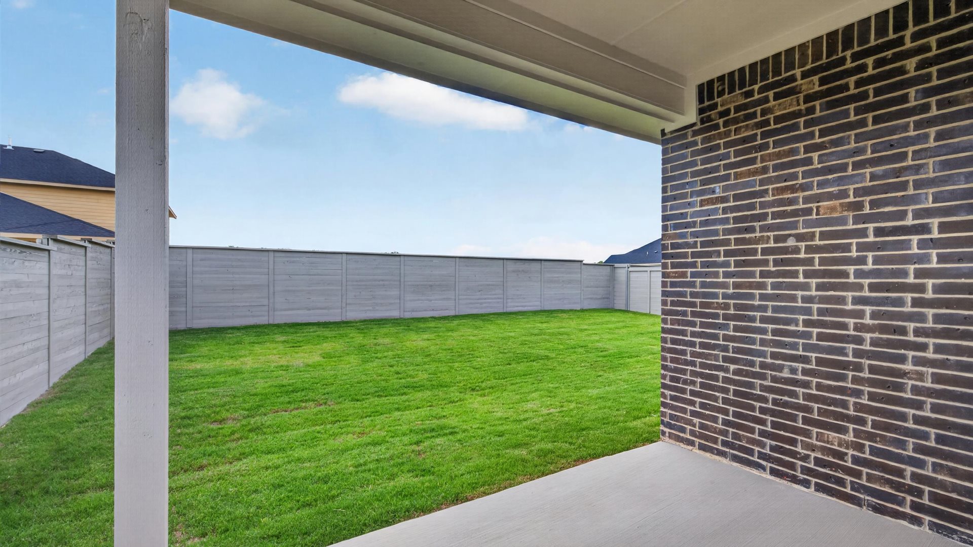 Covered back patio overlooking backyard