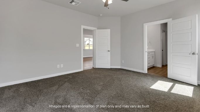 Primary bedroom with plush carpet floors and light allowing double windows