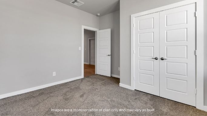 Guest bedroom 3 with plush carpet floors and spacious closet