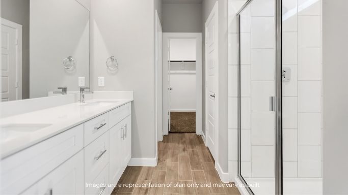 Modern primary bath with dual sinks and walk-in shower.