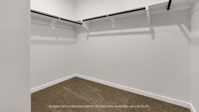 Large walk-in closet with built-in shelving.