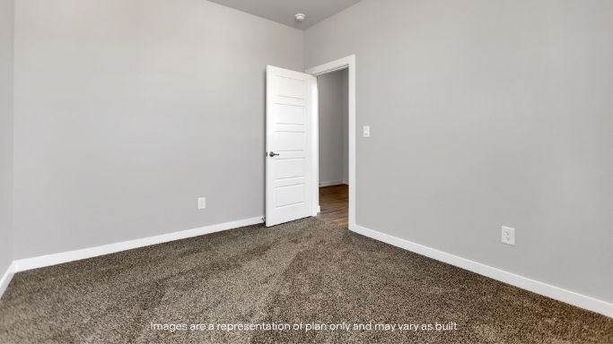 Secondary bedroom with soft carpet and neutral tones.