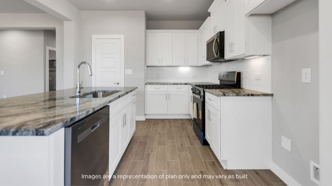 Sleek kitchen with white cabinetry, granite countertops, and stainless steel appliances.