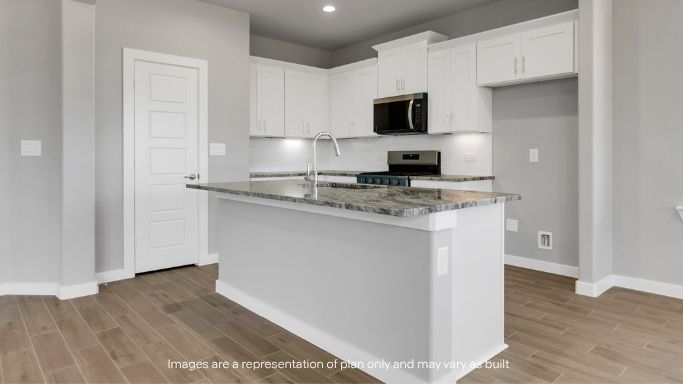 Open kitchen with oversized island and modern finishes throughout.