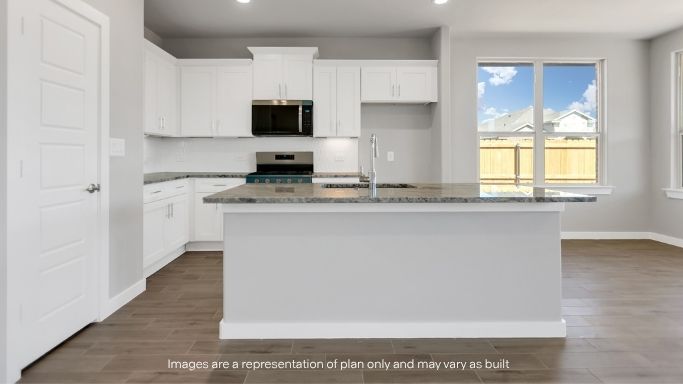 Bright kitchen and dining area with backyard views and natural light.