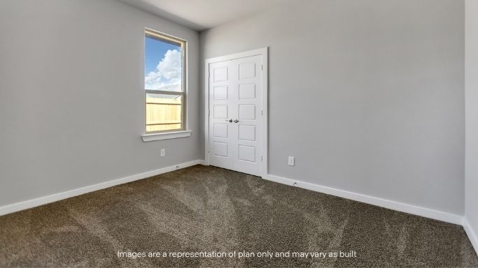 Guest bedroom 2 with side window and plush carpet floor
