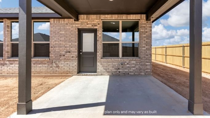 Covered back patio area overlooking spacious backyard